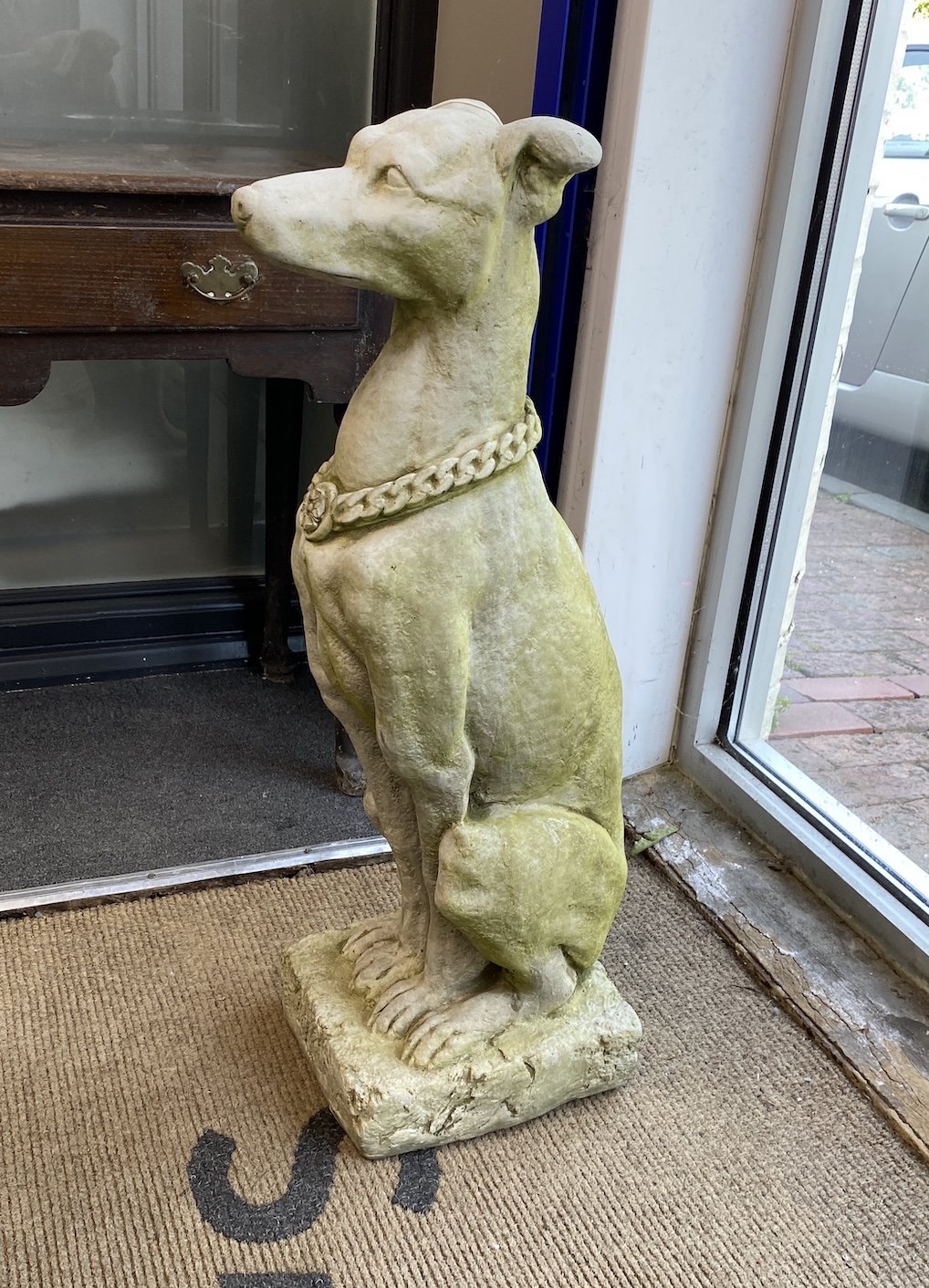 A pair of reconstituted stone seated greyhound garden ornaments, height 79cm
